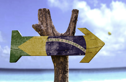 Brazil wooden sign with a beach on background